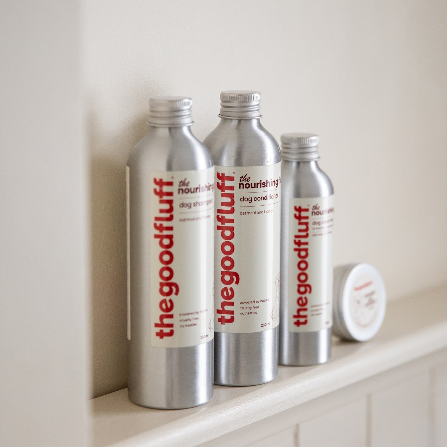 The Good Fluff Nourishing Fluff Collection on a neutral shelf with focus on the natural dog conditioner