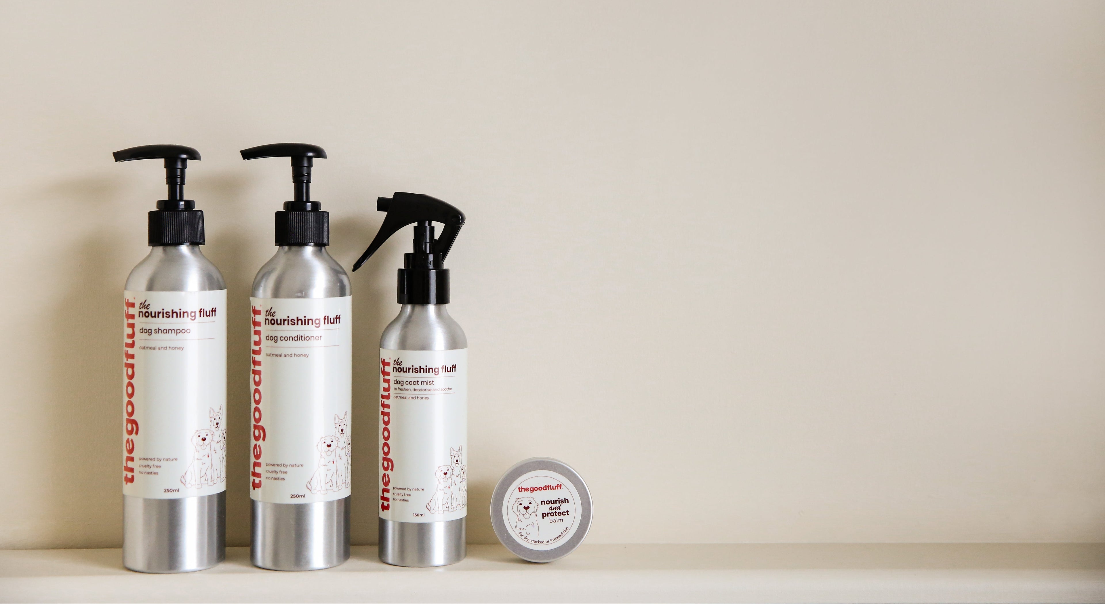 The Good Fluff Nourishing Fluff collection. 3 Aluminium bottles and paw balm on a shelf.
