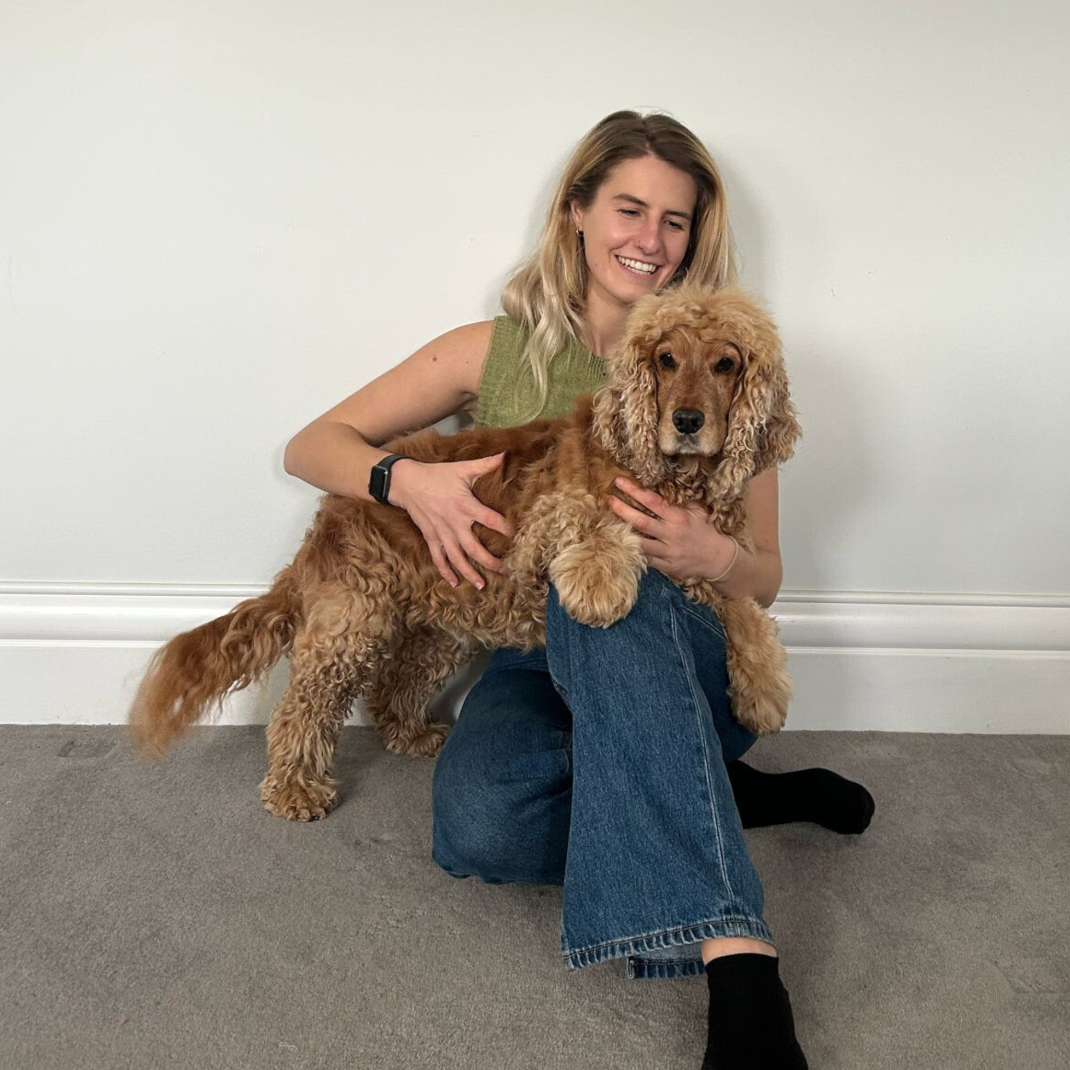 Amy the co-founder of the Good Fluff with Reggie a fluff golden cocker spaniel on her knee